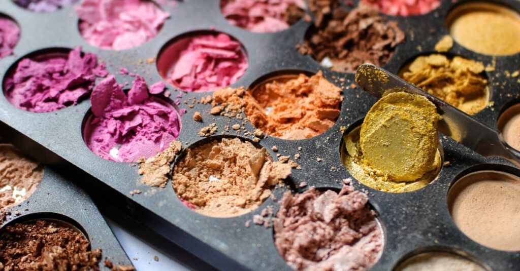 Colorful makeup palette with crushed eyeshadows in various hues.